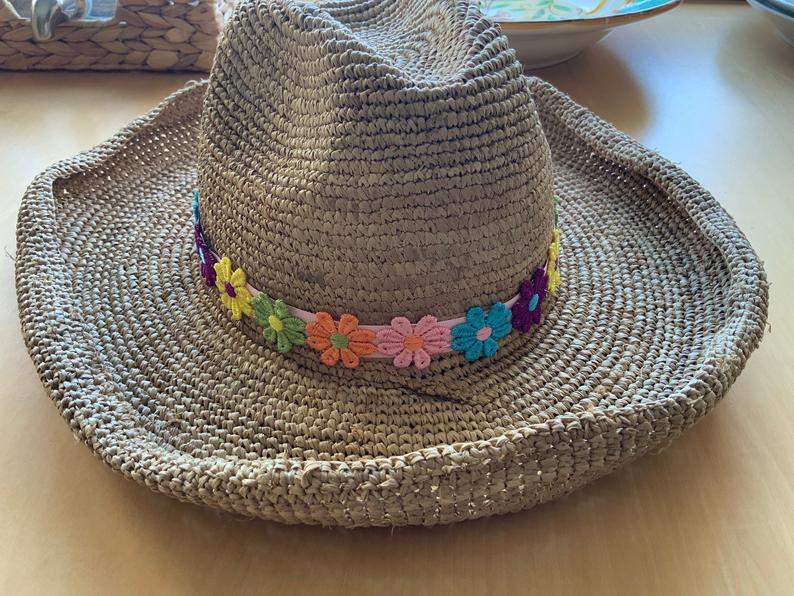 Straw cowboy hat with flower band