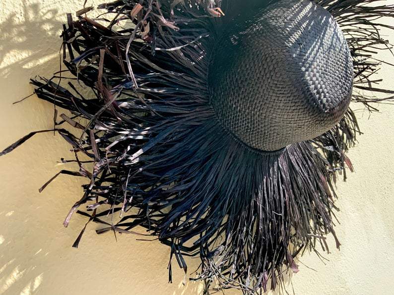 Black fringed straw hat